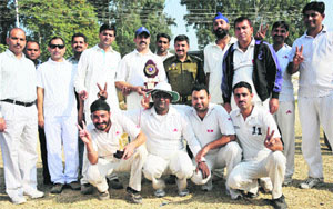 The winning team poses for a photograph after a match at the Railway Ground in Jammu on Sunday.