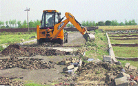 A bulldozer at work in an illegal colony in Ludhiana. 