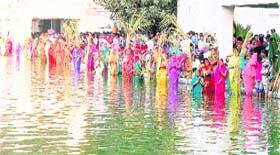 Women offer prayers to the sun on the occasion of Chhat Puja at Durgiana Temple in Amritsar on Monday.
