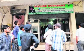 Youths protest outside the office of a city-based travel agency, alleging fraud of several lakhs in Amritsar on Monday.