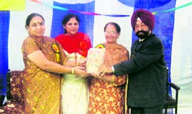 Haryana Punjabi Sahitya Akademi director Sukhchain Singh Bhandari (right) felicitates teachers during a function of the akademi at Nejadela Kalan in Sirsa.