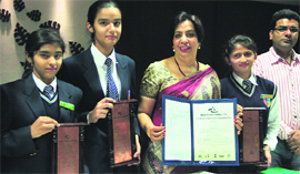 The team of three students of Police DAV Public School who have won IGNITE Award, along with school principal Rashmi Vij, in Jalandhar on Monday.