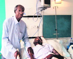 African student Yannick Nihangaza's father Nestor Ntibateganya at a private hospital in Patiala.