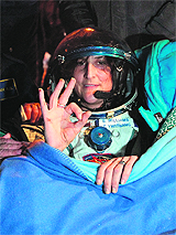 Sunita Williams gestures shortly after her landing in the Soyuz capsule in Kazakhstan on Monday. 