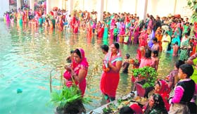 Women offer prayers to Sun God on the occasion of Chhat Puja at Durgiana Temple in Amritsar on Tuesday