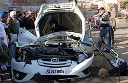 The mangled remains of a Verna car, which collided with a truck, in Malout on Monda night