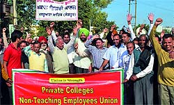 Aided college teachers block the Bibiwala road to protest against the state government seeking gratuity and pension