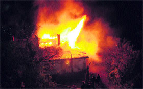 Firefighters try to extinguish the fire that broke out at a building in Shimla on Monday night. No casualty was reported.