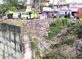 A heap of garbage lies on the national highway at Paprola