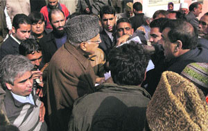 National Conference president Farooq Abdullah interacts with sarpanches in Srinagar.
