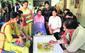 Students of the PCM SD College for Women take training in painting from an artist during a workshop in Jalandhar on Monday.