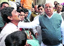 RJD chief Lalu Prasad visits the family of a victim, who was killed in a stampede during the Chhath Festival, in Patna on Tuesday