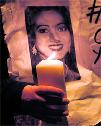 A woman holds a candle during a vigil in memory of Savita Halappanavar and to press for changes to abortion laws in Dublin. 
