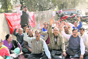 Class IV employees of the state government stage a dharna in front of the Vidhan Sabha in support of their demands in Dehradun on Wednesday.