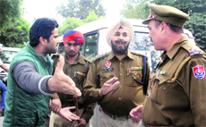 A member of a gang argues with policemen following a group clash outside the Judicial Complex in Jalandhar on Wednesday. 