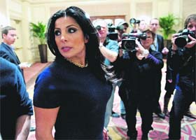 Natalie Khawam, the twin sister of Jill Kelley, who is involved in the Petraeus scandal, is pursued by the media following a news conference in Washington