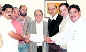 Mayor Bakshi Ram Arora accepts a nomination paper from a candidate for the district BJP (Rural) president poll at Circut House