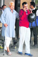 80-year-old Onkar Nath on his way to the New OPD block in the PGI with a bandaged leg. Tribune photo: S Chandan