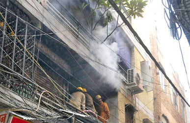 Smoke billows out of a shop which caught fire at Gandhi Nagar Cloth Market, East Delhi on Thursday.