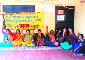 Women of Kunao village sit on a dharna in support of their demand for the implementation of the Forest Rights Act for the development of infrastructure in their village near Rshikesh on Thursday