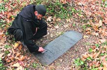 Shakeel Ahmad Bakshi cleans the stone epitaph on Robert Thorps grave in Srinagar. photo by writer