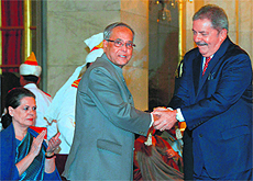 President Pranab Mukherjee shakes hands with former Brazilian President Luiz Inacio Lula da Silva at Rashtrapati Bhavan in New Delhi on Thursday.