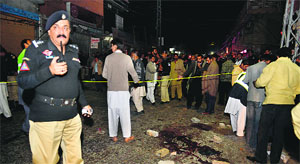 Pakistani rescuers and policemen at the blast site in Rawalpindi on Thursday