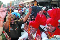 Senior Superintendent of Police Ravcharan Singh Brar dances to the Dhol beats during a procession carried out in the city; and a group of boys dressed as jangams perform in the procession. 