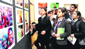 Students have a look at photographs during an exhibition put by the Coloured Leaf Photographic Group at the UGB art gallery in Dehradun on Friday. 