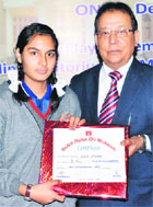 Kriti Sharma, a student of Kendriya Vidyalaya Upper Camp, being honoured in Dehradun on Friday. 