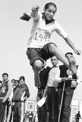 A student leaps in the long jump competition during the annual sports meet of S.S. International School, Newal, in Karnal on Friday.