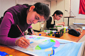 Students take part in an inter-college poster-making competition to mark the communal harmony campaign week in Jammu on Friday.