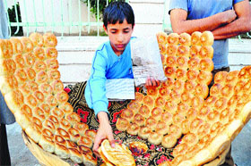 A boy sells Kashmiri bakery items outside the CPO Mosque in the Panjthirthi area of Jammu.