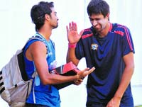 Rahul Sharma shares a joke with Saurashtras Jaidev Unadkat ahead of their match. Tribune photo: Vicky Gharu