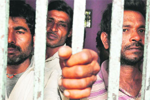 Indian fishermen in a police lockup in Karachi on Friday. Pakistani Coast Guards arrested 26 Indian fishermen and seized their boats for allegedly fishing in its waters. 
