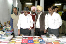 CPS Sarup Chand Singla (left) visits a stall at the book fair. 