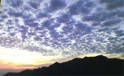 Clouds hover over mountains in Mussoorie.