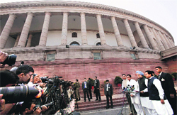 Prime Minister Manmohan Singh addresses the media outside Parliament. 