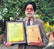 Daljit Singh Grewal, president of the association, with citations.
