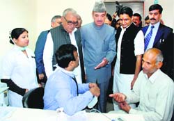 Haryana Chief Minister Bhupinder Singh Hooda, Union Health and Family Welfare Minister Gulam Nabi Azad and MP Deepender Singh Hooda interact with a patient and a doctor after the inauguration of the Outreach OPD of the All-India Institute of Medical Sciences-2 at Badhsa village in Jhajjar district on Saturday. photo: manoj dhaka