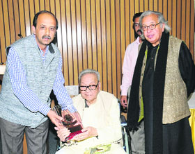 Artist Raza being felicitated at a function in New Delhi on Friday.