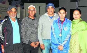 A boxer poses with her gold medal at the Sher-e-Punjab Sports Academy, Chakar, near Jagraon on Saturday.