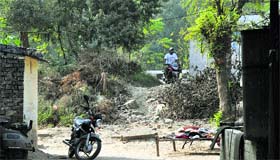 A broken boundary wall on the PAU campus provides easy access to outsiders.