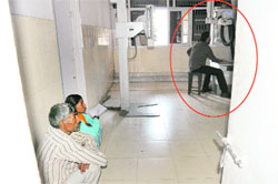 Unaware of the danger it poses, patients await their turn inside an X-ray room even as another patient (encircled) undergoes a test at the GMSH-16 .