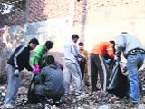 Volunteers of MAD during a cleanliness drive in Dehradun on Sunday.