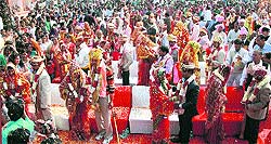 Couples tie the knot during a mass marriage ceremony at Gaushala Maidan in Gurgaon