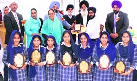 tudents with their trophies during the 26th All India Shabad Gayan at the MGN College, Adarsh Nagar, in Jalandhar on Sunday.