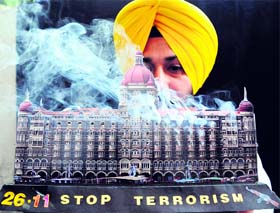 Artist Harwinder Singh displays a miniature model of Hotel Taj to mark the anniversary of 26/11 terrorist attacks.