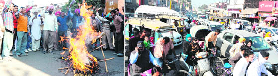Activists of the Punjab Nirman Majdoor Union burn the effigy of the Punjab Government during a protest in Amritsar. (Bottom) the protest by the union led to a huge traffic jam at Hall Gate in Amritsar on Monday.