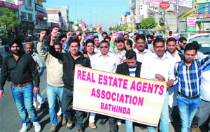 Real estate agents holding a protest rally in Bathinda on Monday. 